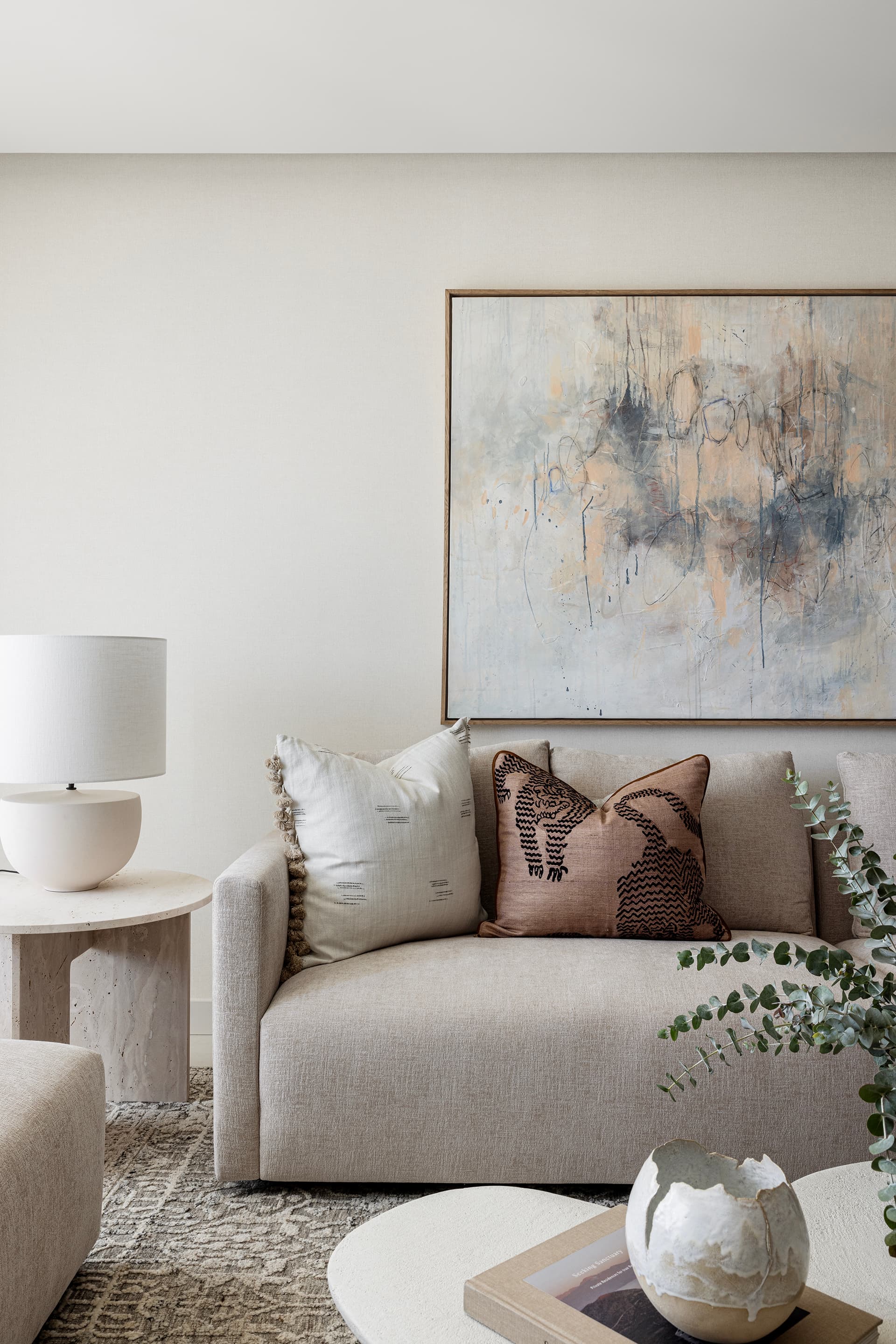 Living room corner with artwork and lamp