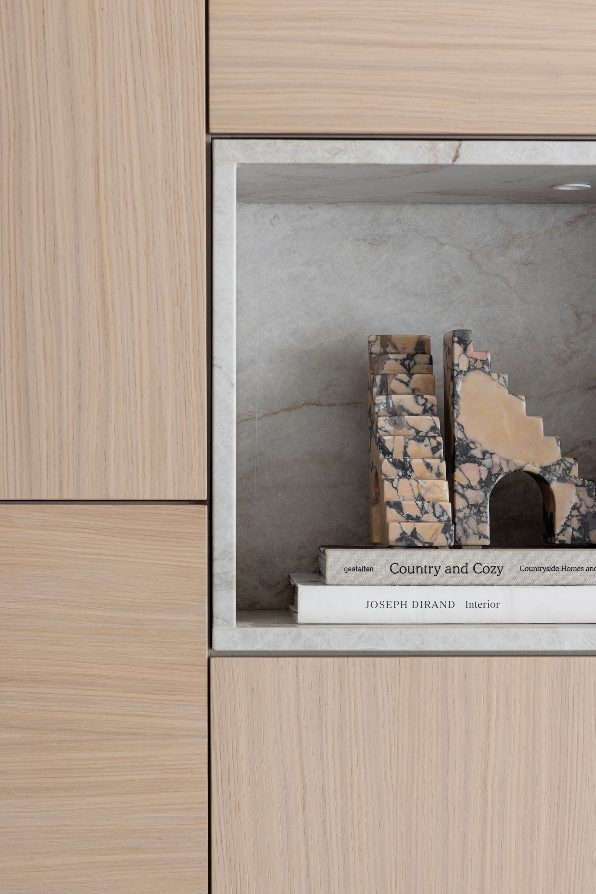 Built-in oak niche with marble bookends