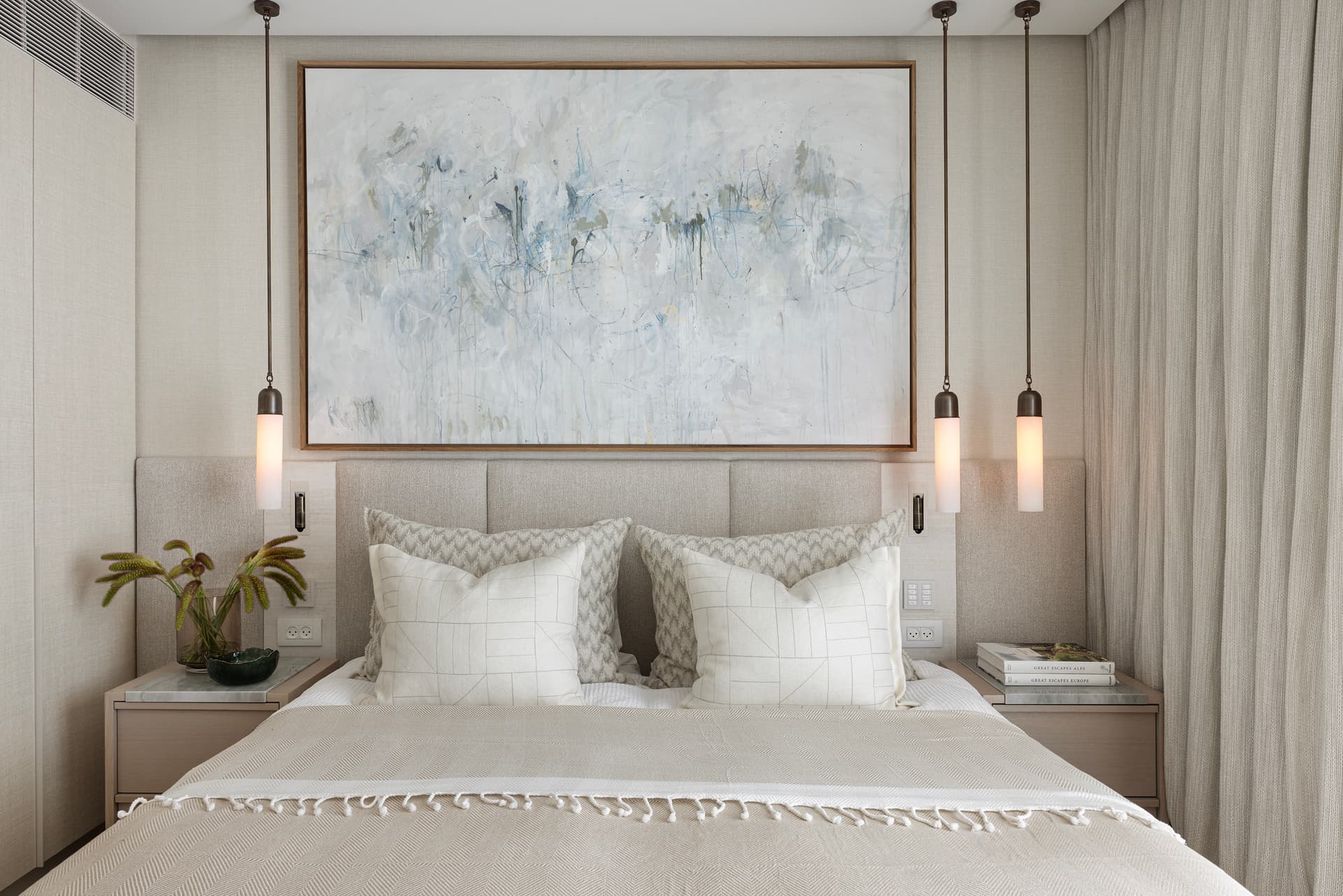 Master bedroom with symmetrical headboard and pendant lights